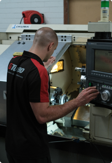 man operating lathe