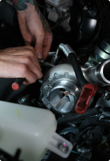 man installing turbocharger